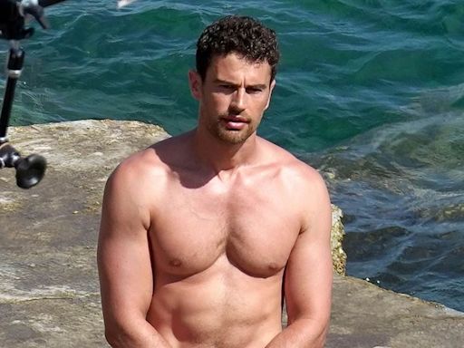 Shirtless Theo James shows off his hunky physique in white trunks