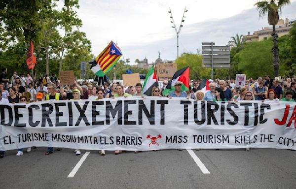 Barcelona anti-tourism protesters fire water pistols at visitors