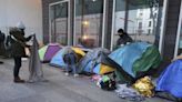 Police clear out a migrant camp in central Paris. Activists say it's a pre-Olympics sweep