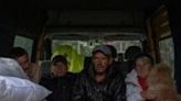 Evacuees wait in a minivan at an evacuation point in Kharkiv as Russia presses its offensive