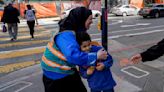 With a vest and a voice, helpers escort kids through San Francisco’s broken Tenderloin streets