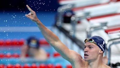 Léon Marchand sets new Olympic record, takes gold in 400-meter IM