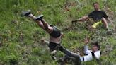 Best pictures from UK's crazy cheese rolling race