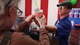 Step right up: Workers in this new gelato shop perform circus acts as they serve up vegan scoops