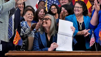 Arizona's Democratic governor signs a bill to repeal 1864 ban on most abortions