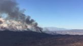 Plumes of black smoke rise from raging wildfire in California