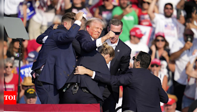 Former US President Donald Trump rushed off stage after apparent gunshots heard during rally - Times of India