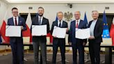 Poland's election winners sign a coalition pact but won't get to govern just yet
