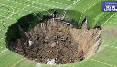 Huge sinkhole opens up under football pitch in Illinois