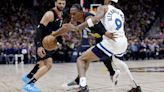 Peyton Watson of the Denver Nuggets attempts to drive past Nickeil Alexander-Walker of the Minnesota Timberwolves during the second quarter in Game 2...