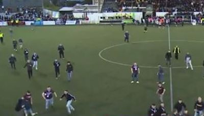 Watch shock moment fans run on pitch and huge brawl breaks out in 'ugly' scenes