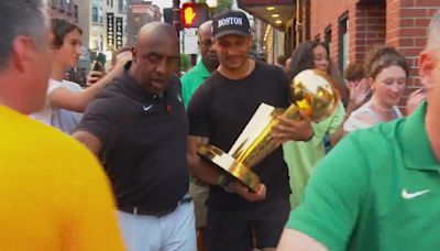 Celtics coach Joe Mazzulla takes championship trophy around North End