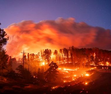 California's largest wildfire of the year explodes in size and destroys scores of buildings