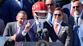 President Joe Biden puts on gifted Chiefs helmet at White House presentation