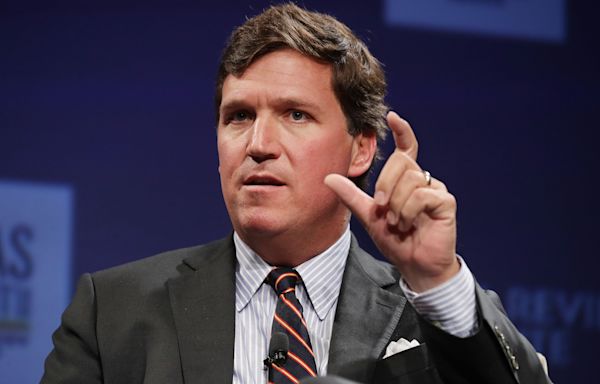 Tucker Carlson appears to laugh as protestor confronts him on Ukraine