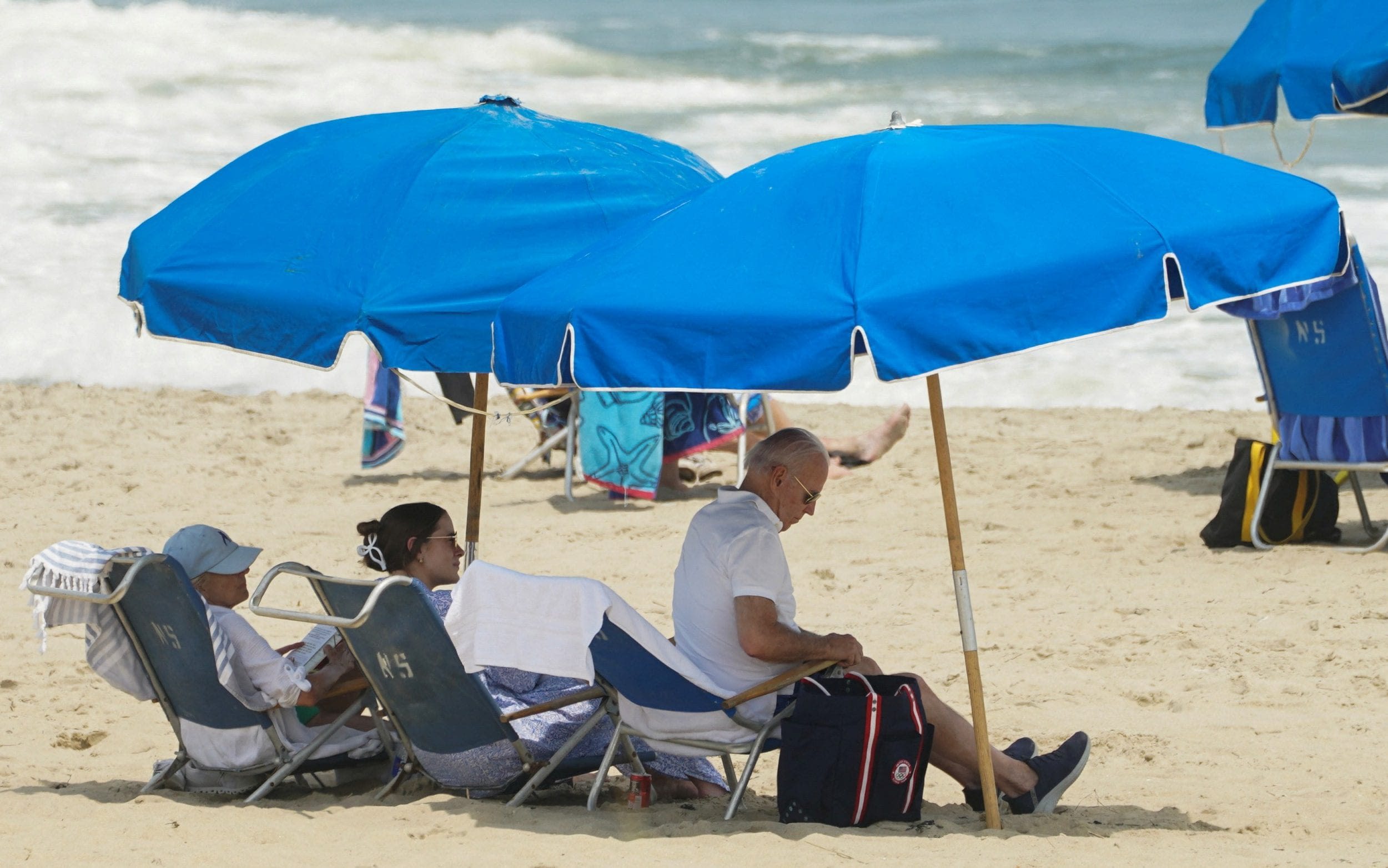 President Joe Biden lounges on beach amid retreat from public view