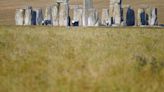 FILE PHOTO: People walk around the Stonehenge stone circle as a second heatwave continues in parts of the country, in Amesbury