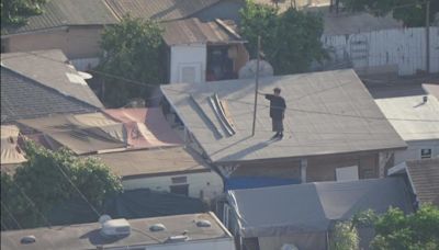 LAPD responds to man on Pacoima rooftop, acting erratically, throwing objects