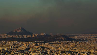 Crews battle scattered fires in Athens suburbs, helped by calmer winds and reinforcements