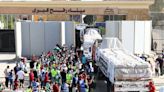 Trucks carrying aid and coffins enter Gaza for first time as Rafah crossing opens