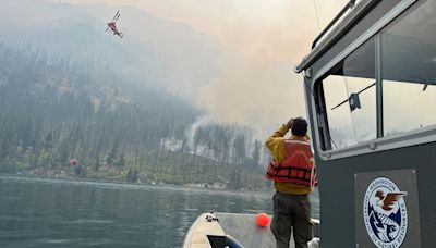 With a fire burning just miles away, residents of a Washington town dig in