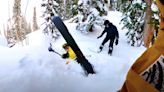 Snowboarders come to the rescue of a skier trapped in snow