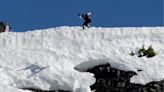 Snowboarder's Friends Celebrate With Enthusiasm Out After Huge Cliff Jump