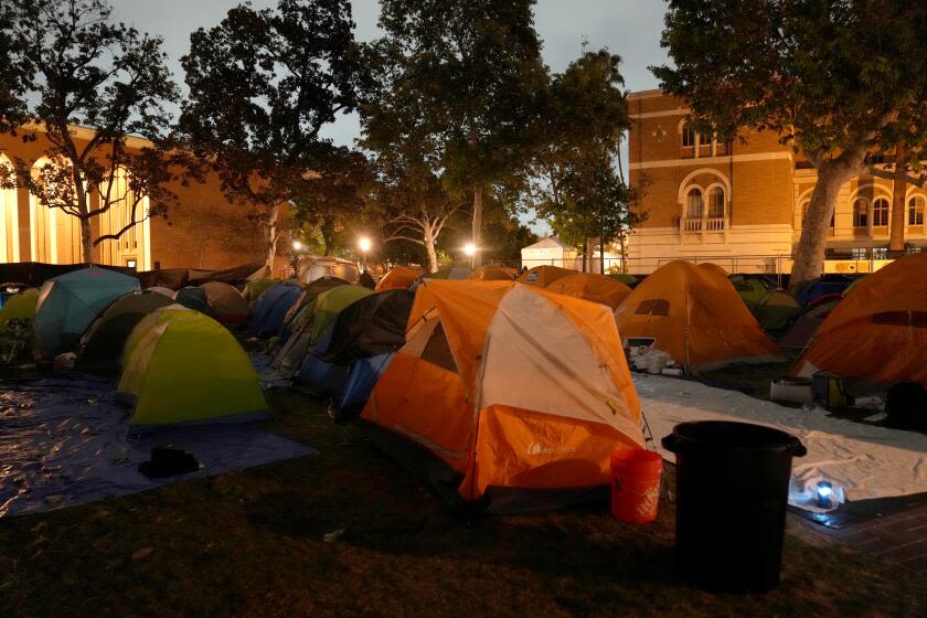 LAPD officers in riot gear swarm USC pro-Palestinian encampment, begin removing tents