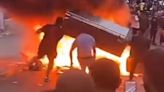 Rioters set FIRE to a fridge in Leeds streets after overturning car