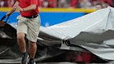 Reds' grounds crew members fight off 'tarp monster' during Cincinnati rain delay