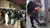 Hundreds protest as officer suspended over clip of man kicked in head at airport