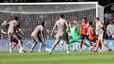 Micky van de Ven scores as 10-man Tottenham go top with win over Luton