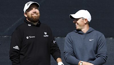 Open day three: Rory McIlroy supporting leader Shane Lowry after missing the cut