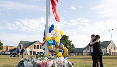 Slain Georgia high school teacher tried to crawl back to students after he was shot