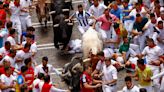 Pamplona bull-runners are tossed around and trampled