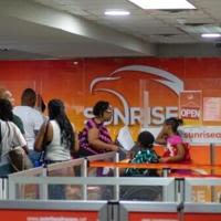 Passengers queue at the Sunrise Airways counter in Haiti's Toussaint Louverture International Airport in Port-au-Prince on May 20, 2024...