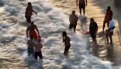 Lifeguards on duty for extra hours due to heat emergency plan rescue swimmer at Rockaway Beach