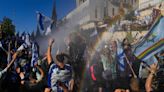 Israel’s parliament votes through Netanyahu’s controversial Supreme Court changes – despite mass protests