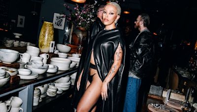 Doja Cat Looks Like a Hot Garment Bag in This Pleather Cape and Thong