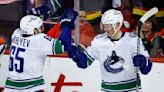 Mikheyev and Lafferty lead Canucks to 4-3 win over Flames