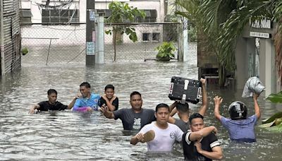 Taiwan prepares for a strong typhoon that worsened monsoon rains in the Philippines, killing 13