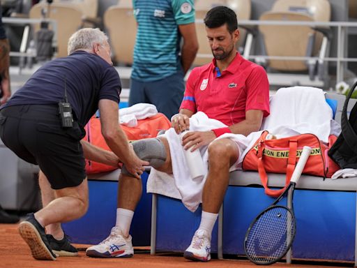 Novak Djokovic's knee injury bothers him at the Paris Olympics but he beats Stefanos Tsitsipas