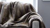West Elm's super-long and plush faux fur throw blankets feel like a warm hug — and they’re on sale right now