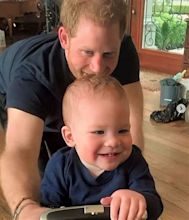 Prince Harry's son Prince Archie cutely holds onto mum Meghan's legs in ...