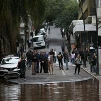 People observe a flooded street at the historical center of Porto Alegre, Rio Grande do Sul state, Brazil