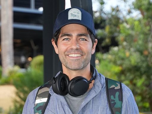 Adrian Grenier is all smiles as he touches down in Sydney