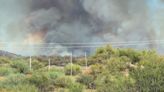 Residents in parts of Arizona’s most populous county asked to evacuate as a wildfire threatens homes