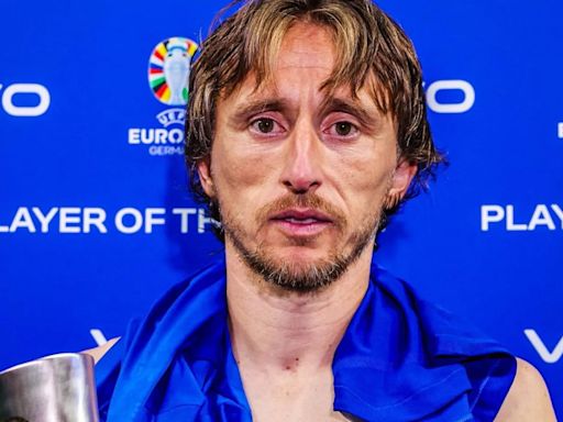 Fans say Luka Modric 'looks like he's been crying' as he poses with MOTM trophy