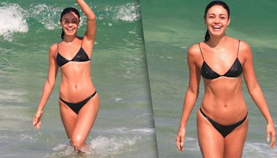 Sorridente, Sophie Charlotte se refresca em mar em dia de sol no Rio