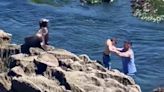 Astonishing moment man positions young boy dangerous close to sea lion